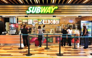 Subway restaurant interior with customers.